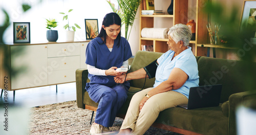 Senior woman, nurse and blood pressure test on sofa for cardiovascular health, heart rate and checkup. Professional, elderly patient and machine in home to monitor hypertension and medical support photo