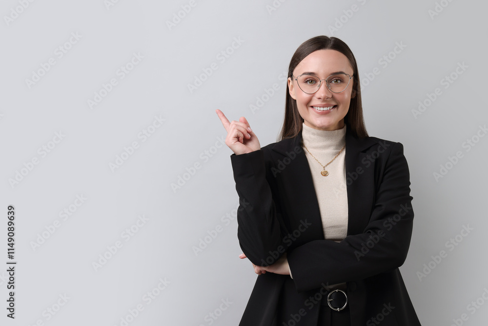 Portrait of businesswoman in glasses on light grey background, space for text Portrait of businesswoman in glasses on light grey background, space for text