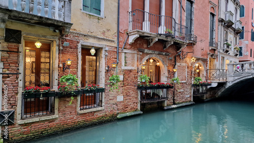 Fototapeta Naklejka Na Ścianę i Meble -  typical canals streets venice italy green water red brick houses magical corners restaurant