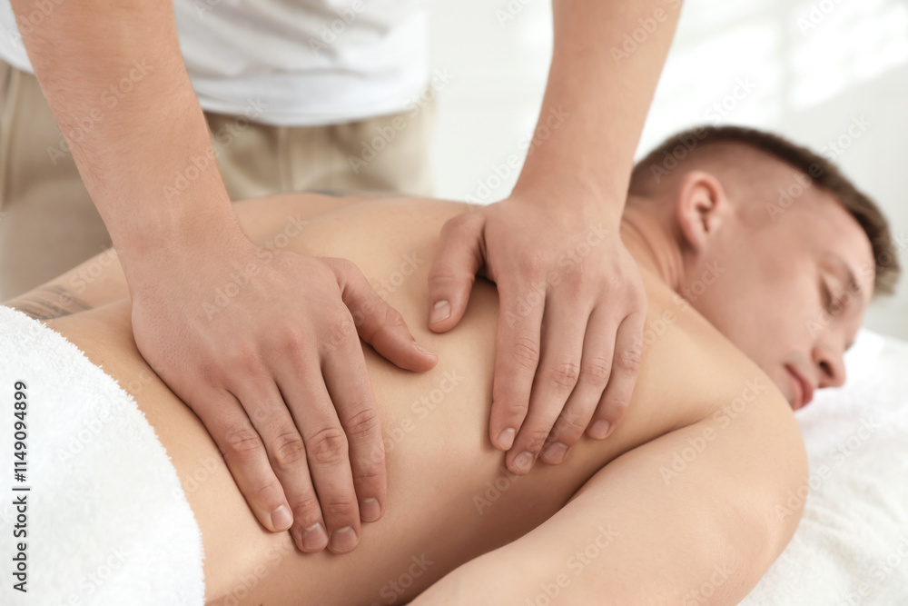 Massage therapist working with patient in clinic, closeup Massage therapist working with patient in clinic, closeup