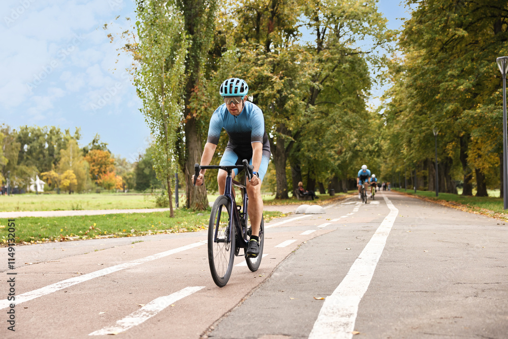 Group of athletic people riding bicycles outdoors
