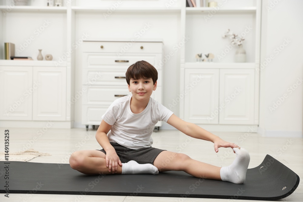 Boy doing exercise on fitness mat at home. Sport activity Boy doing exercise on fitness mat at home. Sport activity