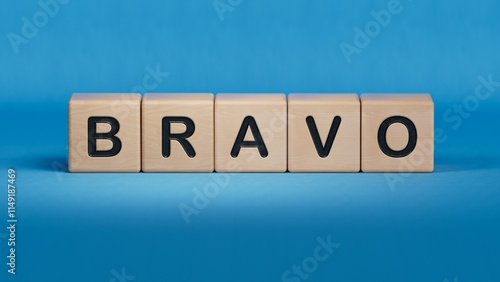 The word bravo appearing wooden cubes. Education concept.close up of wooden elements,Business Concept.3D rendering on blue background.