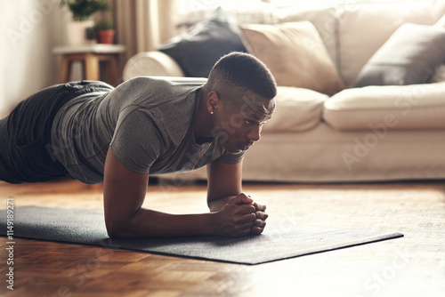 Black man, plank and workout with mat for fitness, exercise or indoor practice on floor at home. African, male person or holding body weight for endurance, strong core or abdominal training at house photo