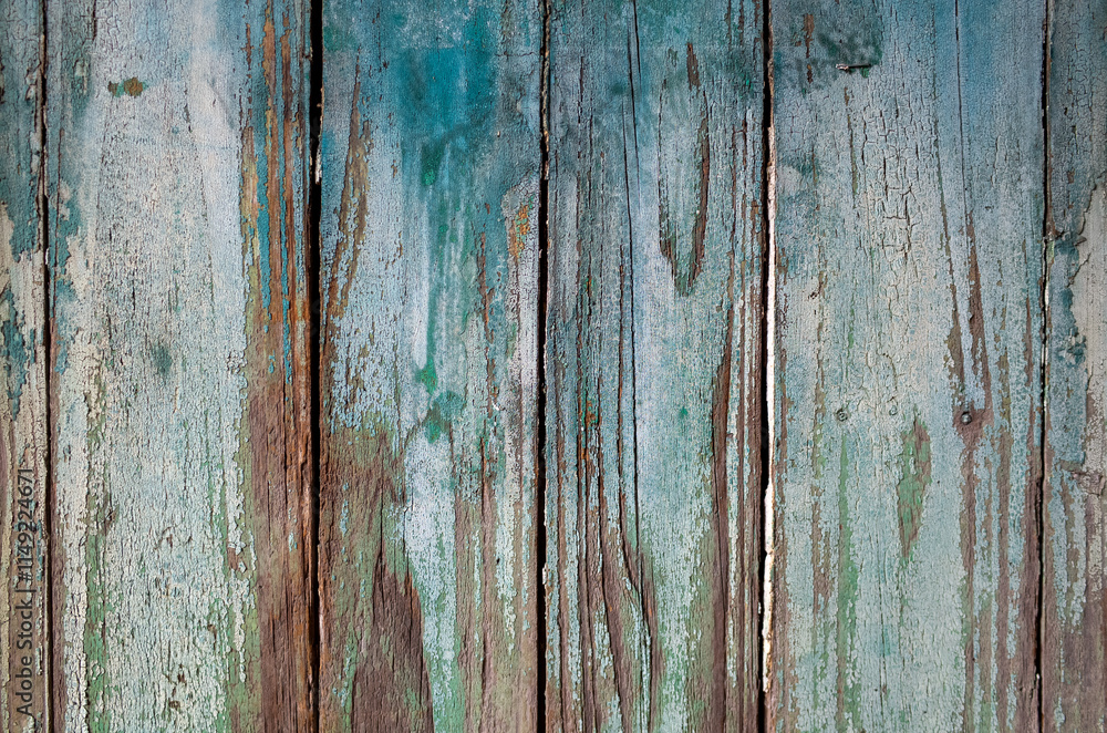 Naklejka premium Vintage weathered wooden texture showing natural wood grain beneath.Old distressed planks background with rustic patina effect, featuring layers of worn paint in blue-green tones and exposed wood. 