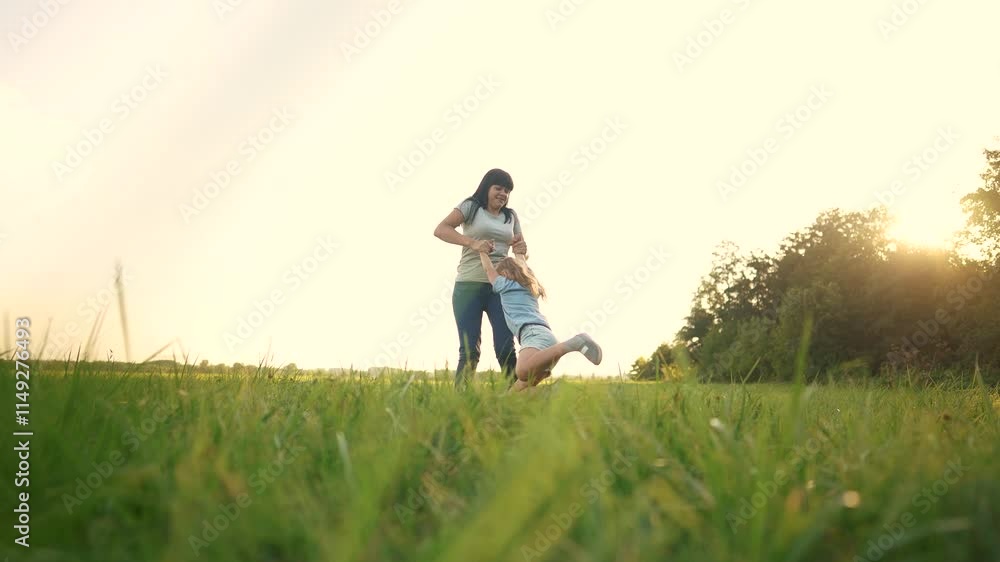 Mother and child walking in a field. Mom, spins, child, daughter, plays, mother, park, summer. Mother and daughter playing in the park in lifestyle summer. Mother and child walking in a field. Mom, spins, child, daughter, plays, mother, park, summer. Mother and daughter playing in the park in lifestyle summer.