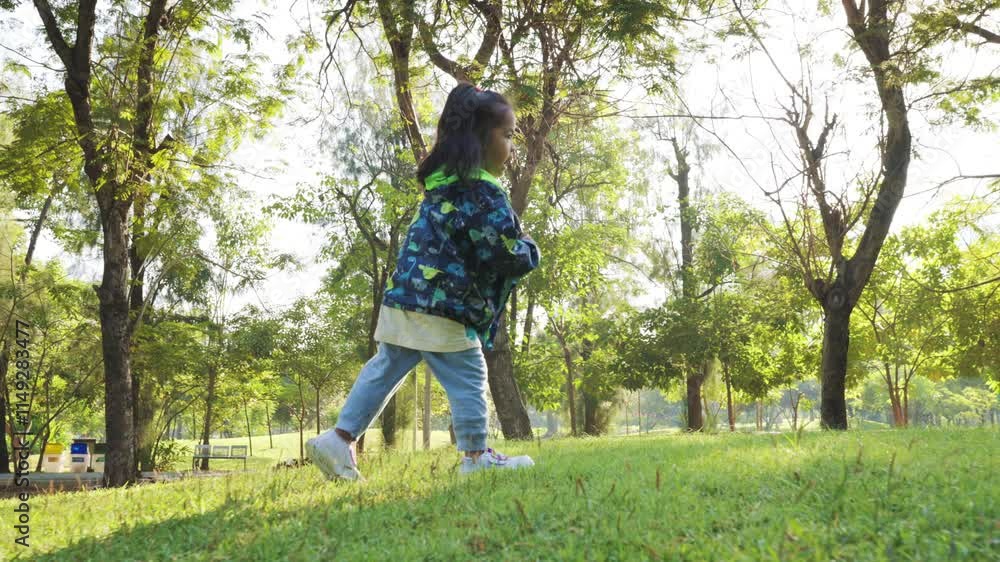 Adorable little 3-4 year girl rnjoy run on green meadow grass city public park morning sunrise slow motion Adorable little 3-4 year girl rnjoy run on green meadow grass city public park morning sunrise slow motion