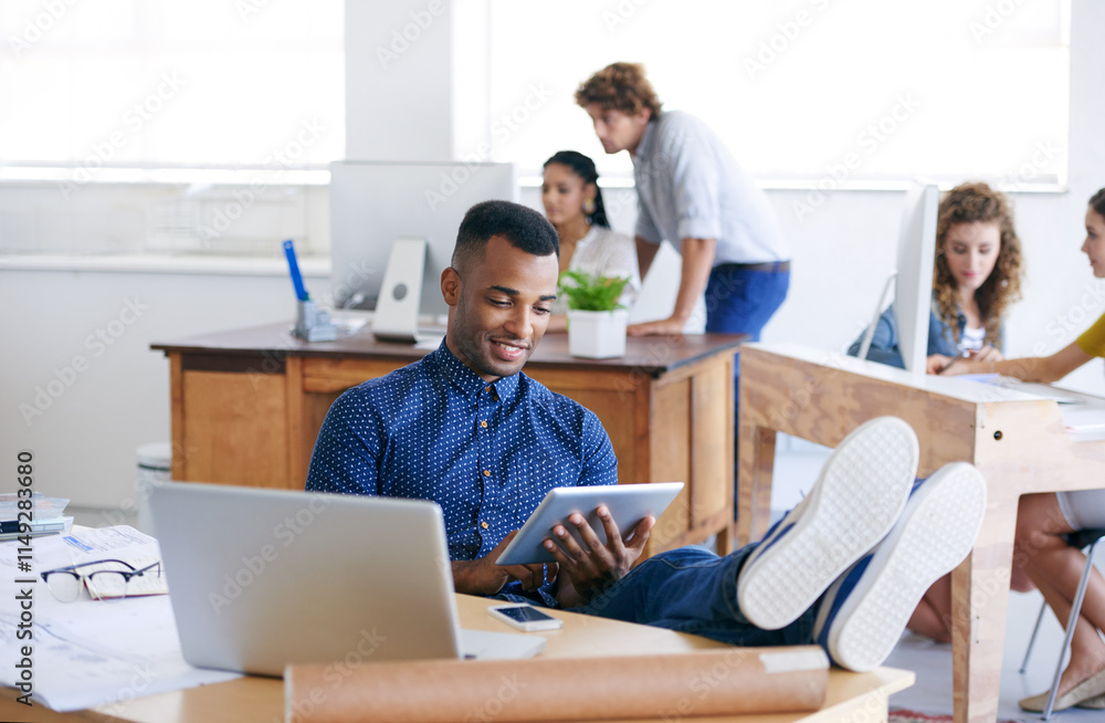 Workplace, creative and man smile at tablet as graphic designer in office of company with colleagues. Male person, relax and working with technology, connection and internet for projects in laptop Workplace, creative and man smile at tablet as graphic designer in office of company with colleagues. Male person, relax and working with technology, connection and internet for projects in laptop