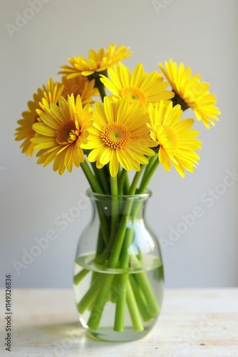 Dandelions in a vase with fresh cut stems and bright yellow blooms, blossoms, bright yellow, arrangement