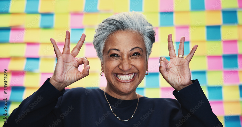 © peopleimages.com - Happy woman, portrait or approval okay with planning for creative project, review or agenda in office. Mature designer, excited or like emoji at sticky note background for OK, yes or new opportunity