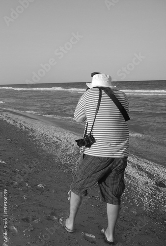 person walking on the beach sea strir photo