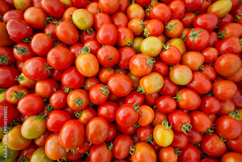 Fresh cherry tomatoes in vibrant red and orange hues, captured in a detailed close-up. Perfectly ripe and ideal for salads, cooking, or food-themed projects