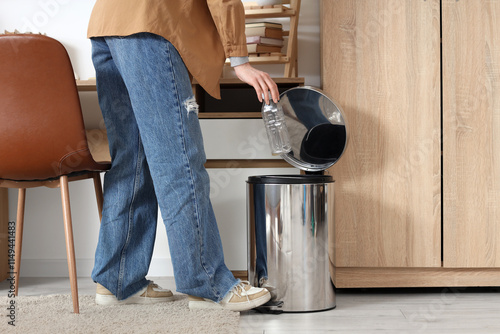 Woman throwing rubbish into...