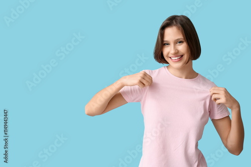 Smiling young woman in pink...