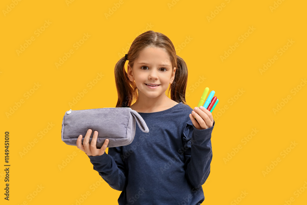 Cute little happy girl with pencil case and markers on yellow background Cute little happy girl with pencil case and markers on yellow background