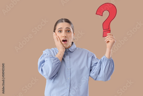 Puzzled woman holding quest...