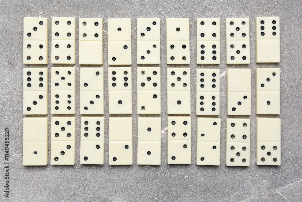 Many white dominos blocks on grey grunge background Many white dominos blocks on grey grunge background