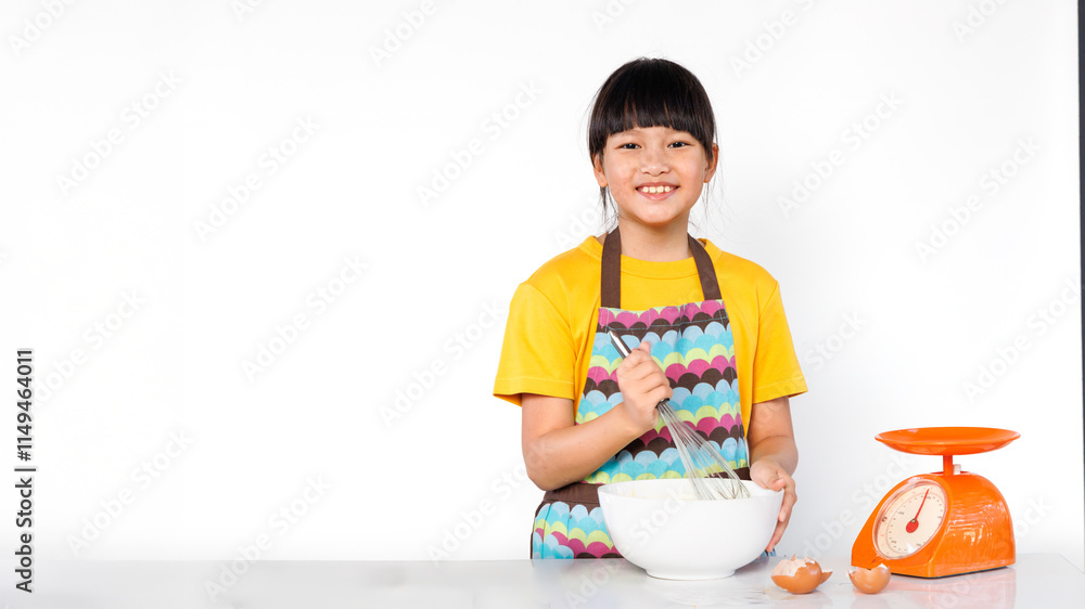 A cheerful little girl is smiling brightly while mixing ingredients to make a cake.. isolated white background. A cheerful little girl is smiling brightly while mixing ingredients to make a cake.. isolated white background.