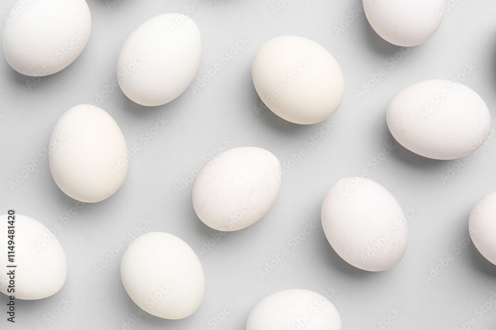 Many raw chicken eggs on grey background Many raw chicken eggs on grey background