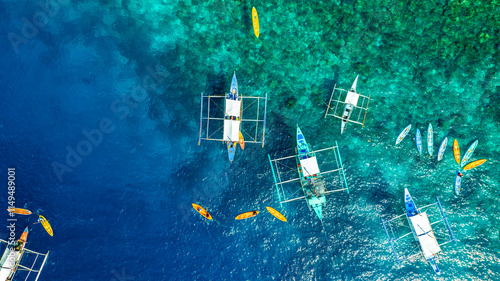 Aerial Top View of Bangka Boats as sand beach  by a crystal clear water. Entalula island, Bacuit Bay, El Nido, Palawan, Philippines. photo