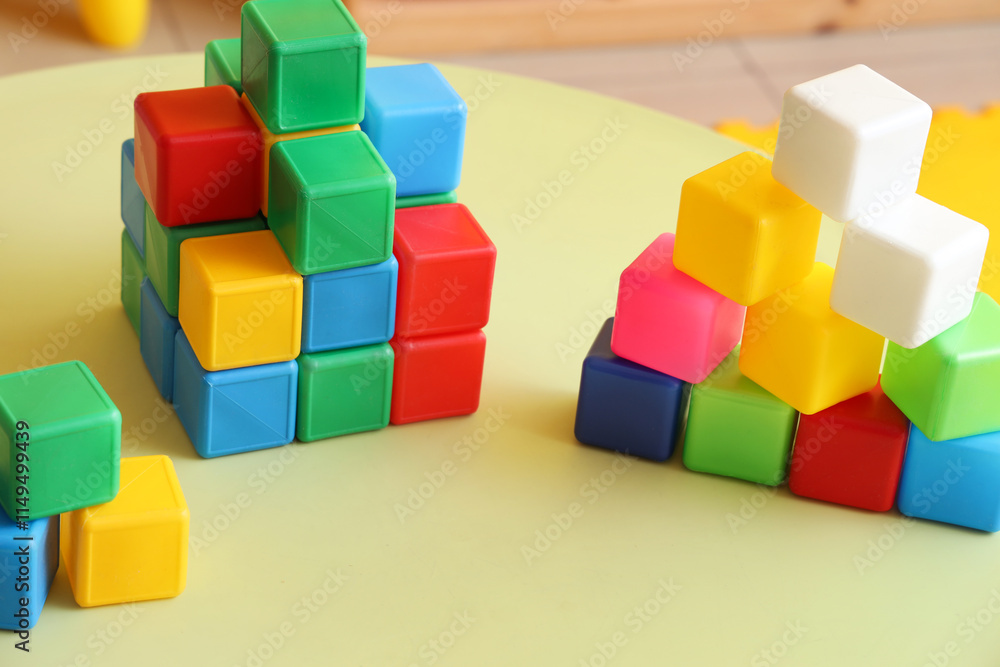 Fototapeta premium Colorful cubes on table in children's room, closeup