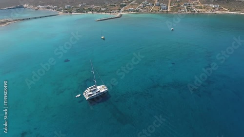 Anchored sailing catamaran. Aerial view of an anchored sailing catamaran in a safe inlet