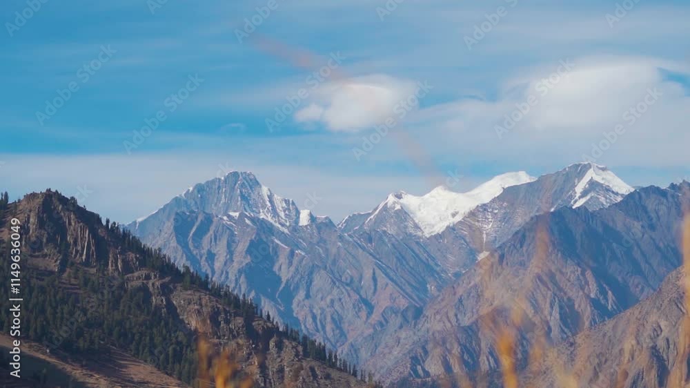 Landscape shot of cirrus stratus clouds above the snowy Himalayan mountain peaks during the winter season as seen from Triloknath village in Tinnan valley at Lahaul and Spiti district, Himachal. Landscape shot of cirrus stratus clouds above the snowy Himalayan mountain peaks during the winter season as seen from Triloknath village in Tinnan valley at Lahaul and Spiti district, Himachal.