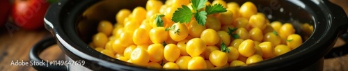 Slow cooker filled with savory and aromatic creamy corn, rich, velvety