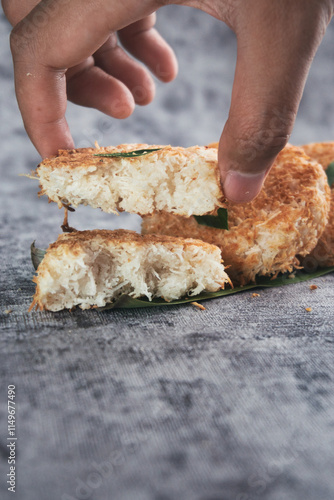 Indonesian Traditional Coconut Cake called Sagon on Banana Leaf with Rustic Background Setting photo