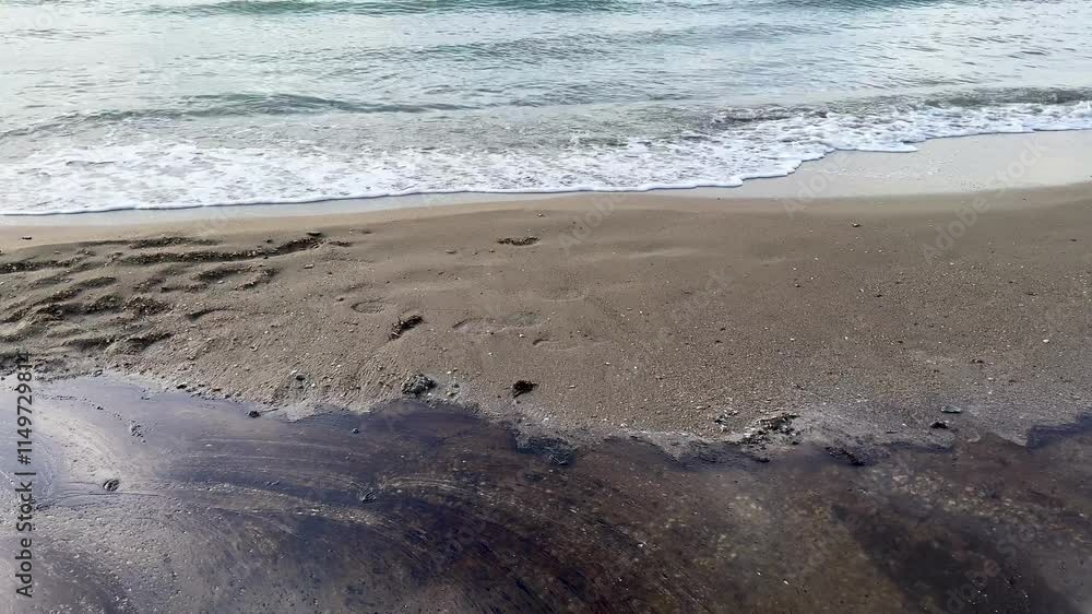 Beach and sea are polluted with fuel oil. Beach oil spill impact, pollution, waste disposal. Beach and sea are polluted with fuel oil. Beach oil spill impact, pollution, waste disposal.