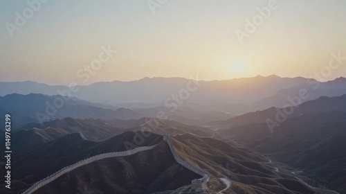 Scenic View of the Great Wall of China at Sunset Surrounded by Majestic Mountains and a Vast Sky, Evoking Natural Beauty and Historical Significance