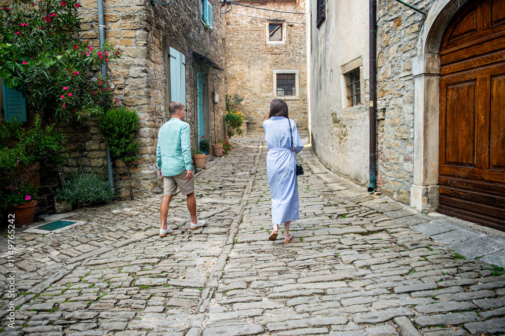 A couple walks around a small medieval town in the Mediterranean country A couple walks around a small medieval town in the Mediterranean country