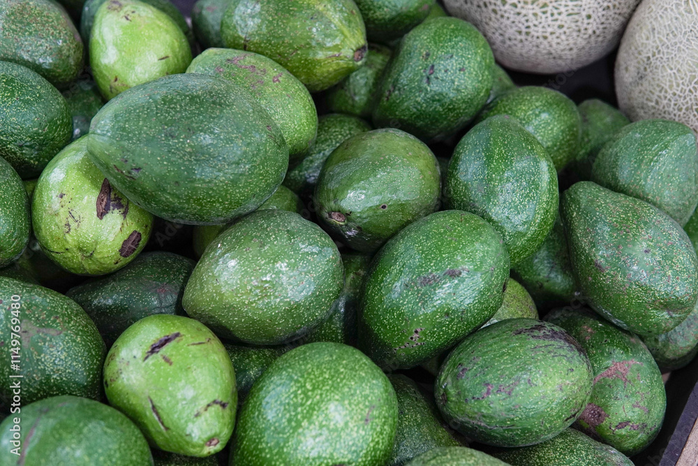 Close up of fresh, whole, ripe avocados arranged together as background. Close up of fresh, whole, ripe avocados arranged together as background.