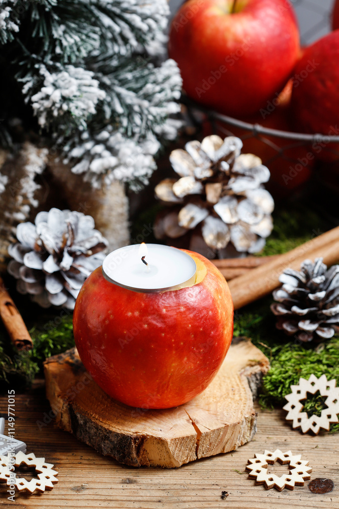 Florist at work: woman shows how to make a Christmas decoration with apple, candle and branches of fir. Step by step, tutorial.