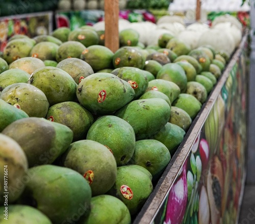 Pontianak, Indonesia – September 26, 2024:Whole fresh mangoes sold in fruit shops are suitable for design purposes, as illustrations for articles about fruits and others. photo