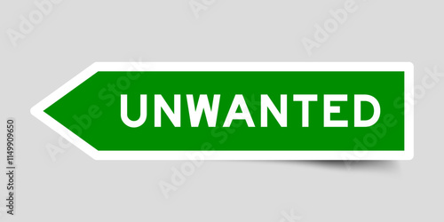 Green color arrow shape sticker label with word unwanted on gray background
