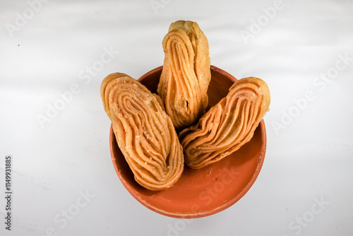 Bengali dessert Goja or Khaza on a bowl. Goja is made of flour and ghee, deep fried and soaked in sugar syrup. It is a popular sweet prepared during festivals like Diwali, Holi, Eid photo