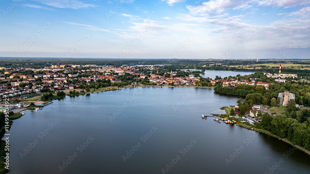 Fototapeta premium Aerial View of Lake Raduń and Wałcz Town, Poland. A breathtaking aerial shot of Lake Raduń with the picturesque Wałcz town, showcasing its serene waters, charming architecture, and natural beauty.