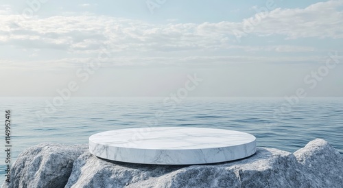 White marble podium on rocks by the sea under a cloudy sky. photo