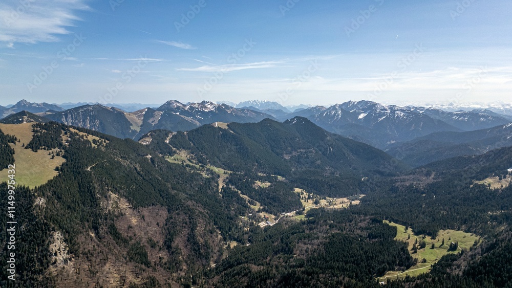 aerial view of the foothills of the Alps in Bavaria. Edge of mountains, sky and clouds. The mountains are covered with snow and forests. aerial view of the foothills of the Alps in Bavaria. Edge of mountains, sky and clouds. The mountains are covered with snow and forests.