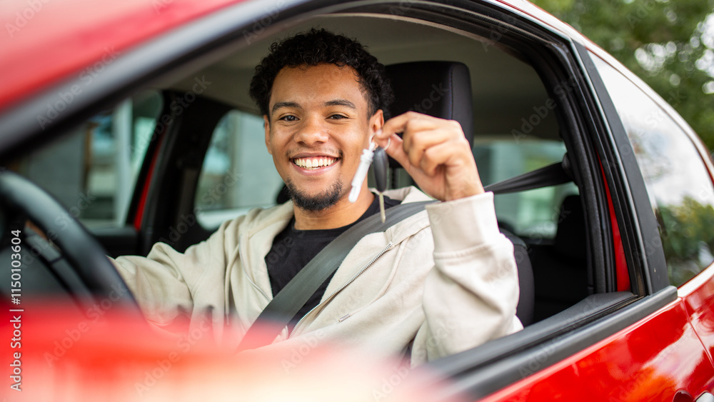 Obraz premium Smiling man with car keys in red car