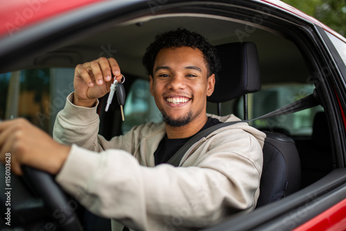 Smiling man in car holding keys through window