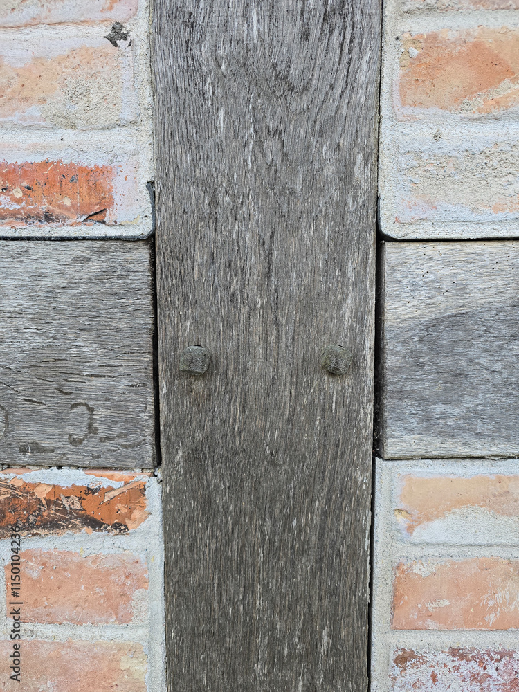 close-up view of a rustic brick wall with a vertical weathered wooden beam in the center. The bricks showcase warm red and orange tones, while the wood adds a natural, vintage touch to the design close-up view of a rustic brick wall with a vertical weathered wooden beam in the center. The bricks showcase warm red and orange tones, while the wood adds a natural, vintage touch to the design