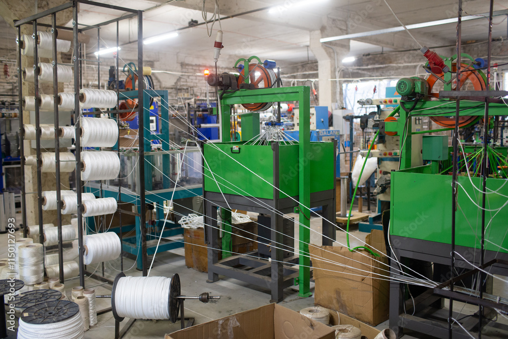 Fototapeta premium Industrial textile manufacturing facility with yarn machine in operation