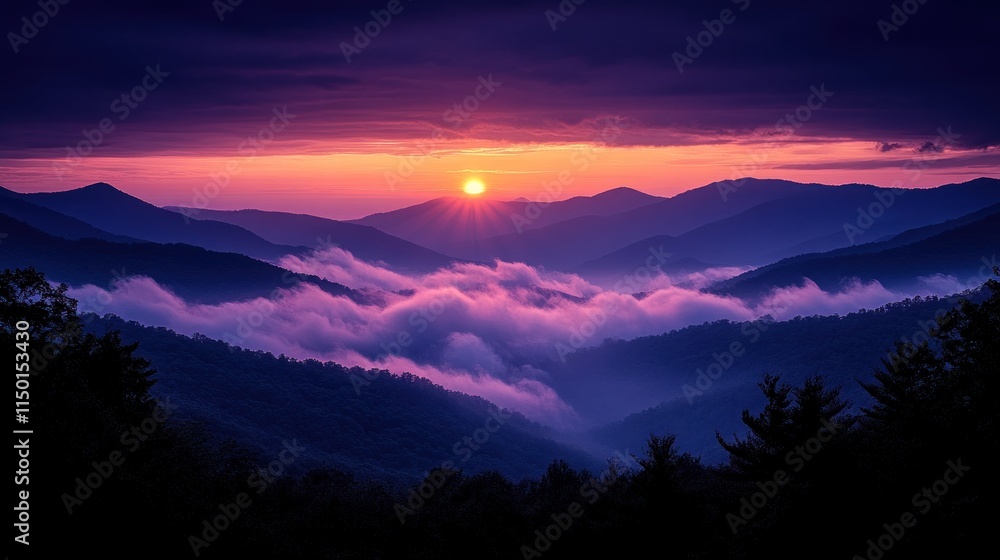Obraz premium Vibrant sunset over misty mountain range.