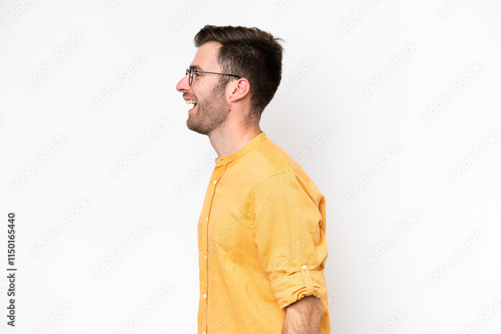 Young caucasian man isolated on white background laughing in lateral position Young caucasian man isolated on white background laughing in lateral position