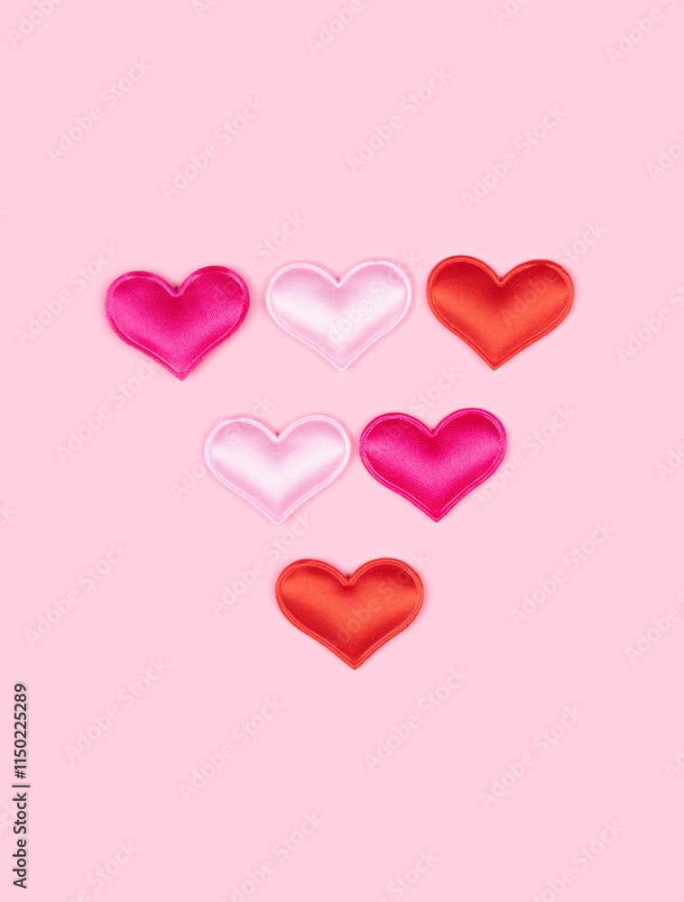 Triangle arrow made of glossy atlas hearts isolated on solid pink background. Love alphabet concept. One punctuation mark of the set of heart's font easy to stacking Triangle arrow made of glossy atlas hearts isolated on solid pink background. Love alphabet concept. One punctuation mark of the set of heart's font easy to stacking