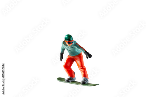 Miniature figurine depicting a snowboarder in mid-motion isolate on white background with clipping path