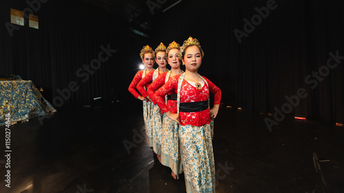 a group of Javanese dancers wearing uniform red costumes creates visual harmony that amazes the audience photo