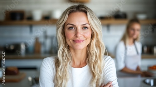 A cheerful blonde woman smiles with confidence, enveloped in a bright and airy room ambiance, representing positivity and self-assuredness in a contemporary setting. photo